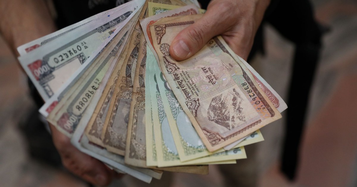 Hands holding a fan of Nepalese rupee banknotes of various denominations (representative photo)