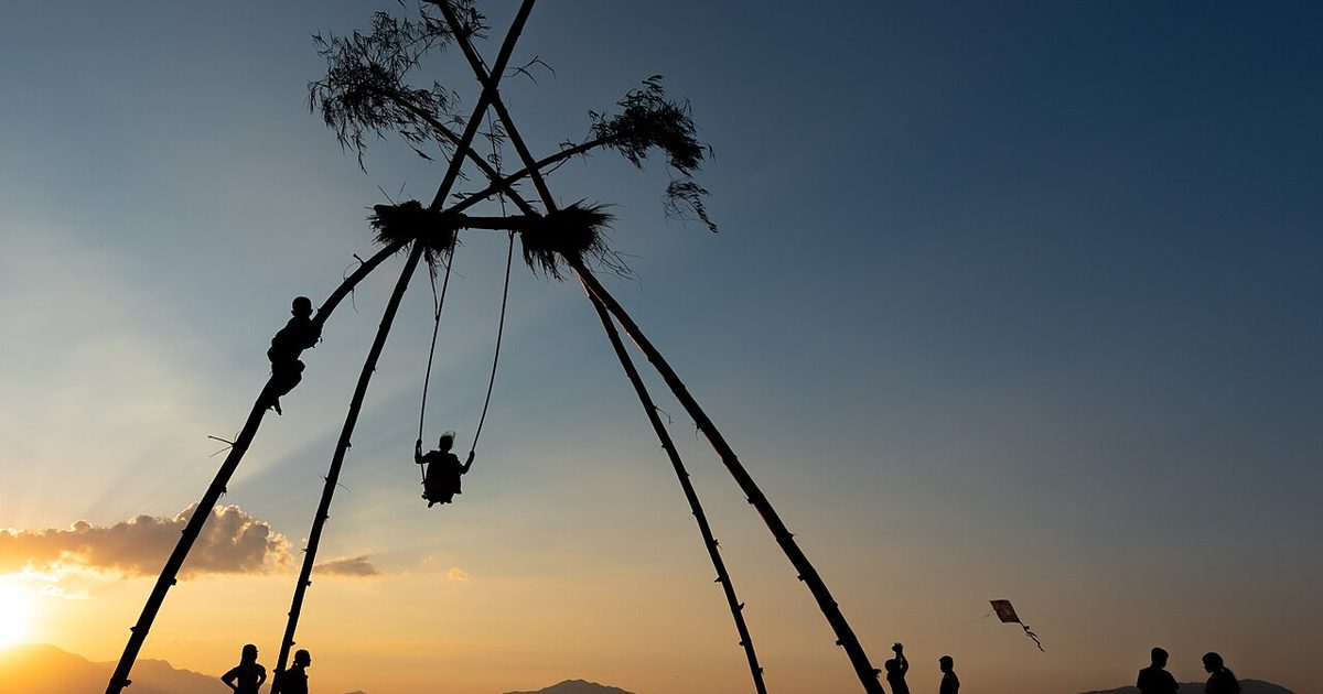 A traditional bamboo linge ping swing and kites at sunset on the outskirts of the Kathmandu valley during Dashain