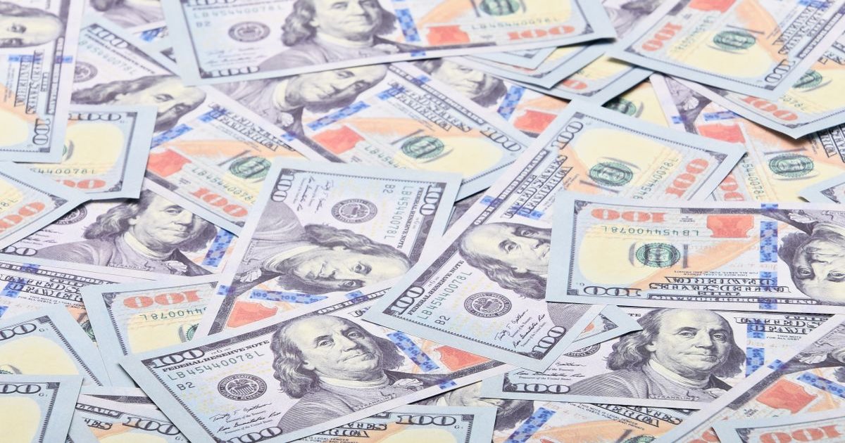 US one-hundred-dollar banknotes fanned out, the currency at the center of NRB's new foreign-exchange caps