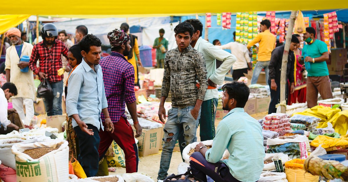 A busy bazaar in Nepal with grain sacks and shoppers, the small traders who form the core clientele of microfinance lenders