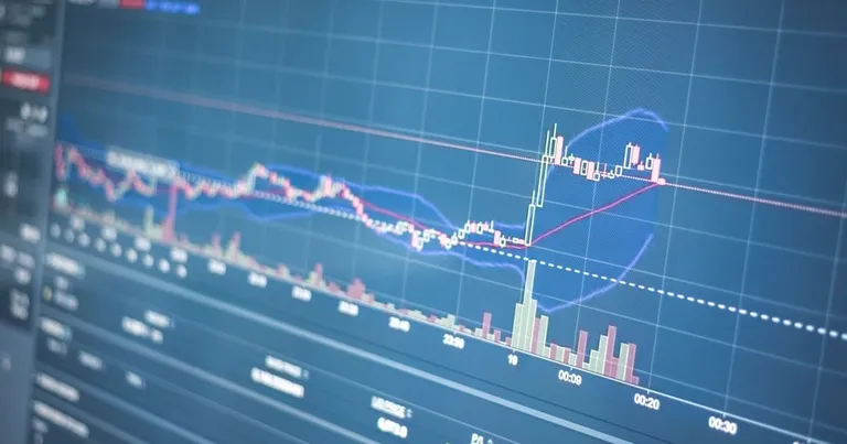 Close-up of a candlestick trading chart on a monitor, the kind of screen on which NEPSE price action plays out after promoter-sale notices
